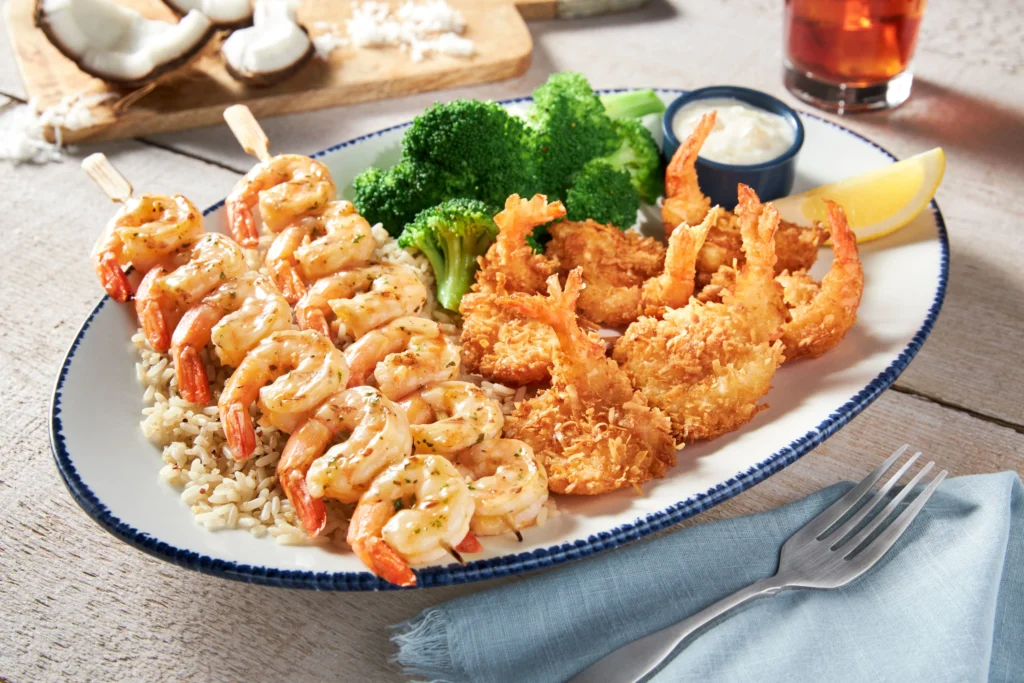Family seafood platter with crispy shrimp, grilled shrimp, biscuits, and fries