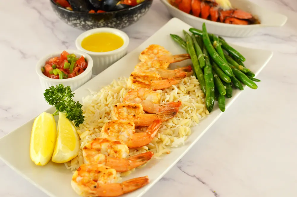 Creamy lobster bisque bowl with grilled lobster tail and seafood chowder homemade style