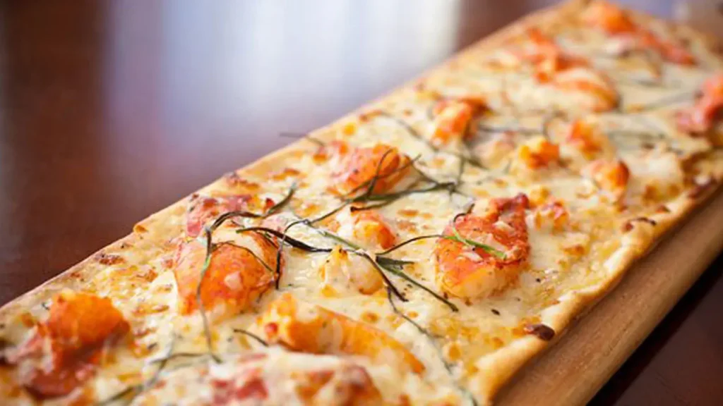 lobster flatbread appetizer with lobster meat melted cheese and crispy flatbread crust