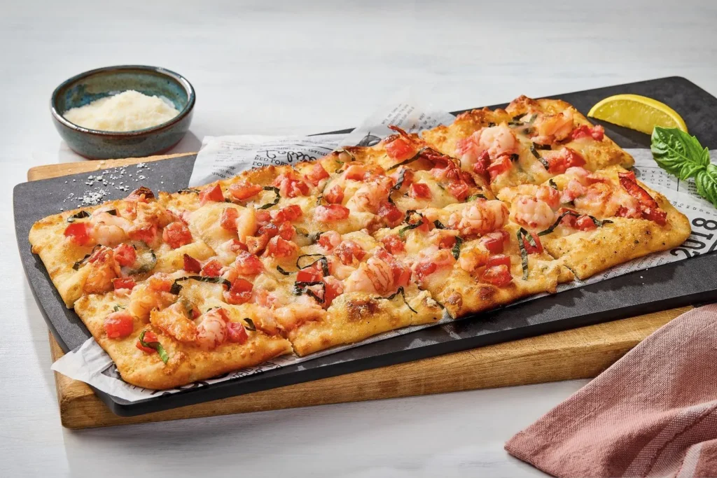 lobster flatbread served with garlic fries salad and seafood side dishes