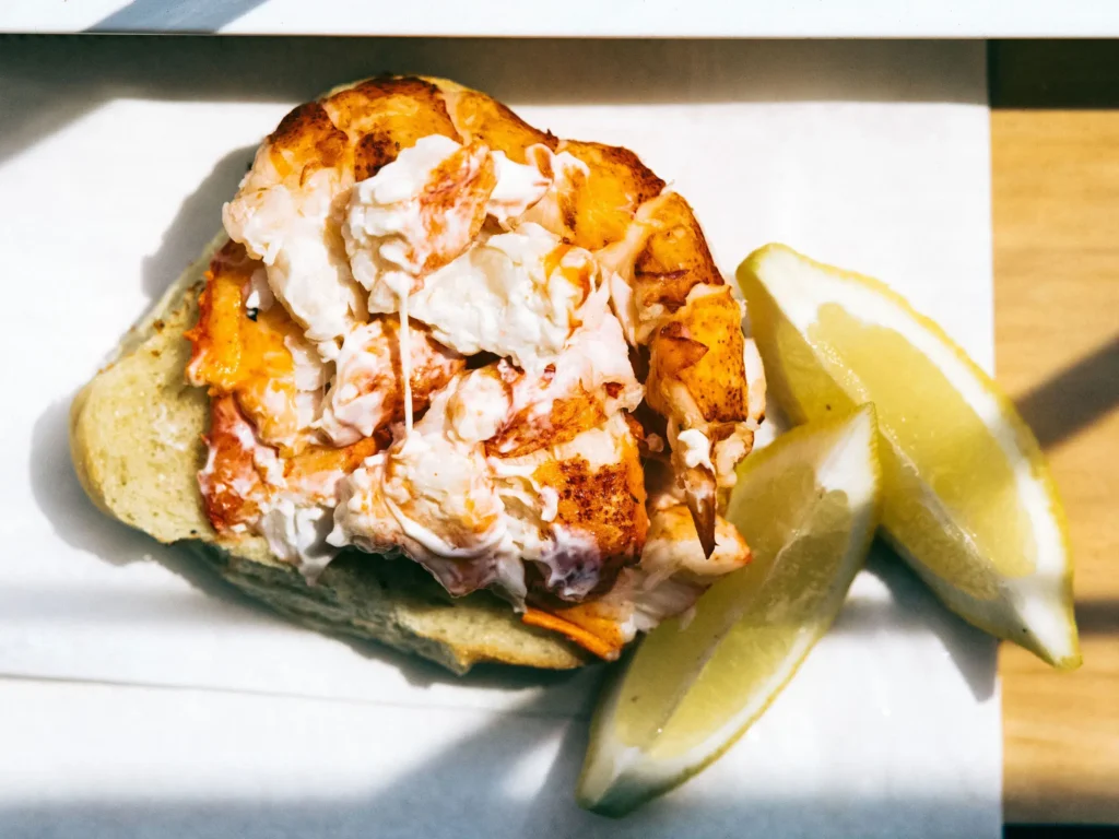 Maine lobster bake tradition explained showing historic coastal cooking with seaweed and hot stones in New England