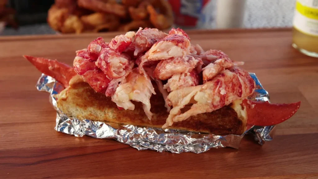 Red Lobster Roll buttery seafood sandwich filled with fresh lobster meat, garlic butter sauce, and toasted bread (2026 seafood menu)