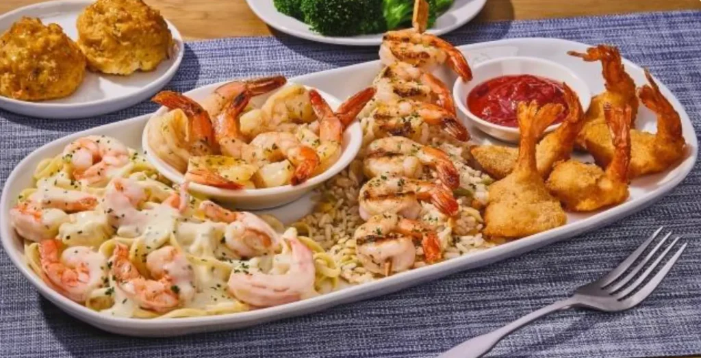 Shrimp Your Way Choose Four seafood combo with garlic shrimp, Cajun shrimp, crispy shrimp, biscuits, and side dishes