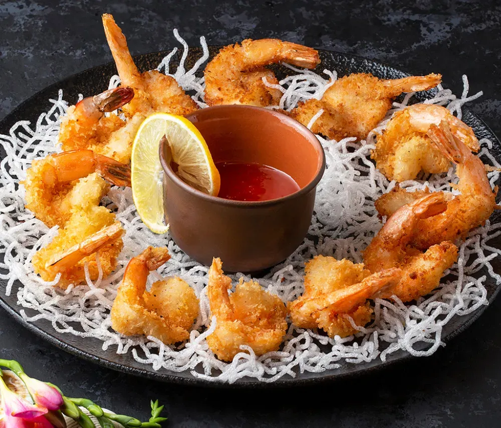 What is crispy dragon shrimp showing crispy fried shrimp tossed in spicy dragon shrimp sauce with garlic and chili glaze