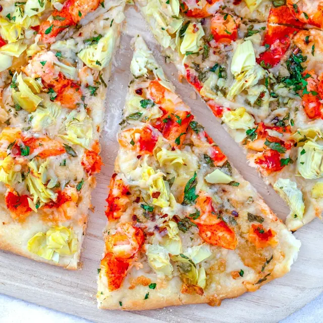 Red Lobster Lobster Flatbread topped with tender lobster meat, melted cheese, roasted tomatoes, and fresh herbs on a crispy flatbread crust.